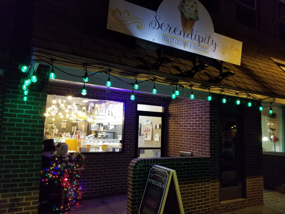 Serendipity storefront at night with string lights
